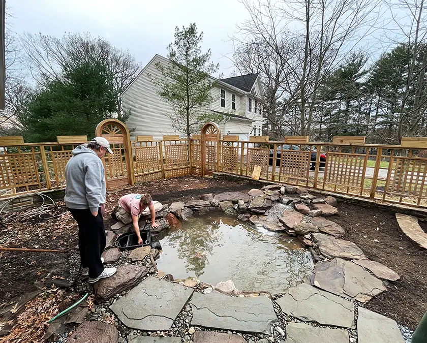 Experienced pond technician inspecting pump and plumbing connections for hidden failures