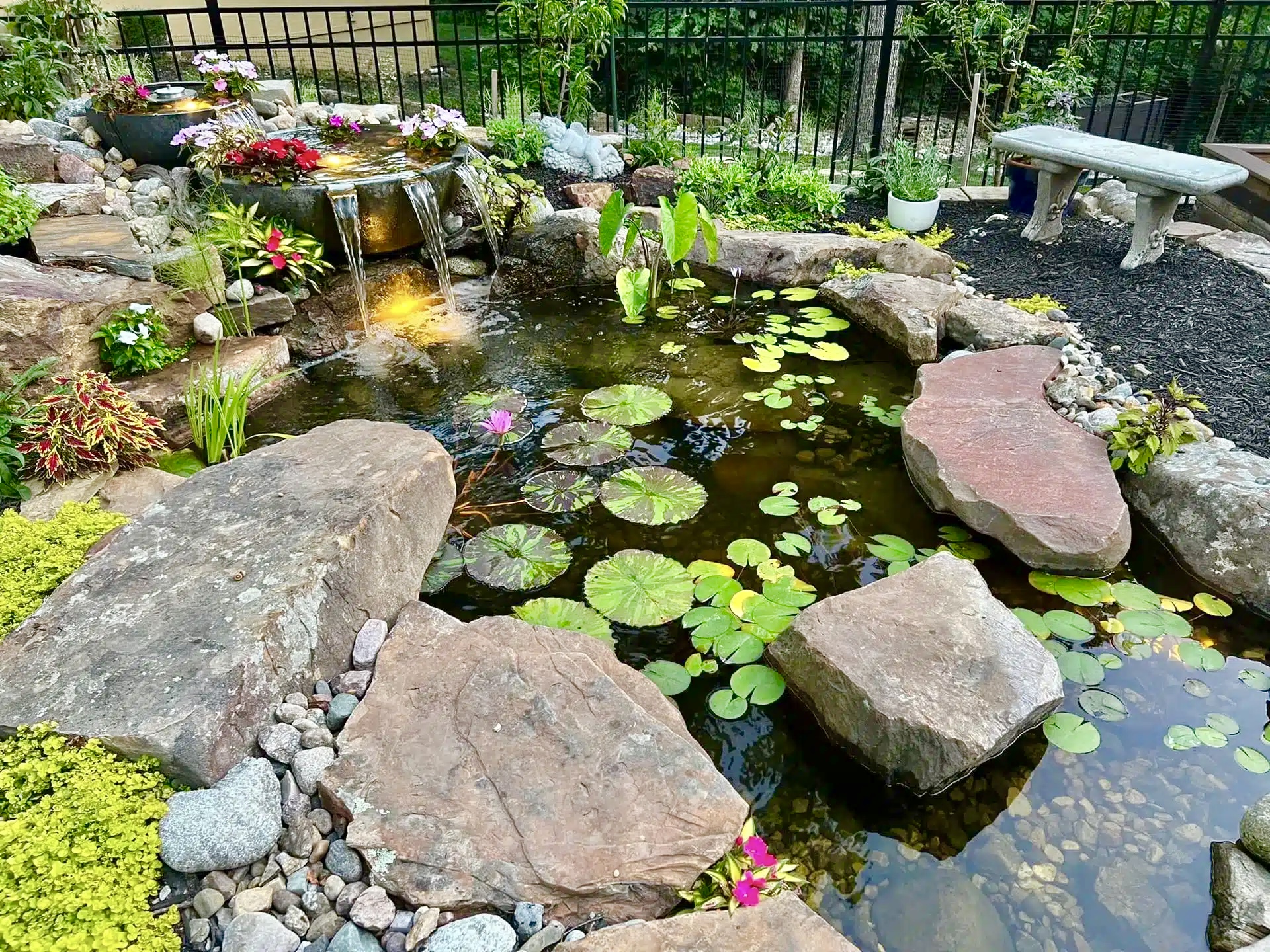 Installer adjusting Water Features stonework in a Moore, OK landscape for balanced flow